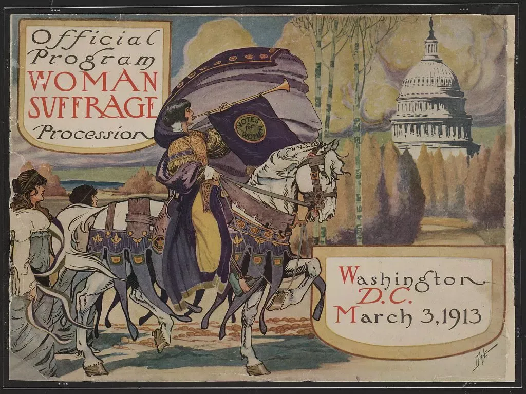 An old, black-and-white photo of a women's suffrage march. Women are holding signs that say 'Votes for Women' and are marching in a street. The image should convey a sense of determination and historical importance. This is a public domain image.