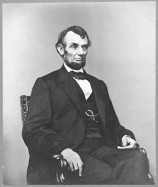 [Abraham Lincoln, three-quarter length portrait, seated, facing right; hair parted on Lincoln's right side]