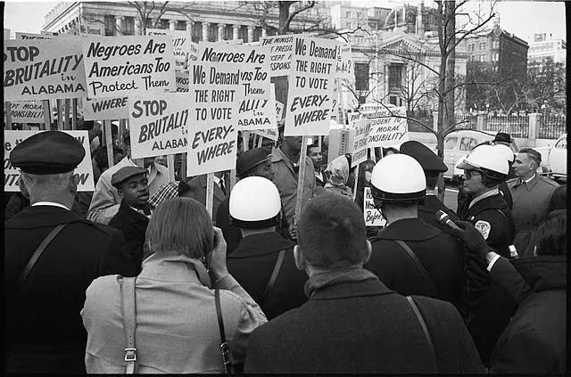 [African American demonstrators outside the White House, with signs 