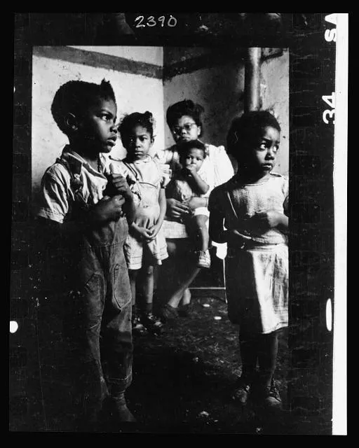 [African American mother and her four children in their tenement apartment]