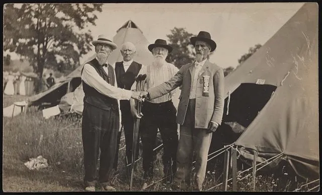 [Civil War Union and Confederate veterans shake hands at encampment]