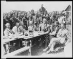 [President Franklin D. Roosevelt having lunch at mess table in Camp Fechner, a Civilian Conservation Corps camp, at Big Meadows, Va., with General Paul B. Malone; Col. Louis Howe; Secretary Ickes of the Interior Department; Robert Fechner, Director of the Civilian Conservation Corps; Secretary Wallace of Agriculture Dept.; and Assist. Secretary of Agriculture Tugwell]