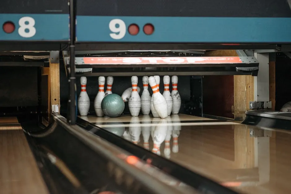 A bowling ball ready to knock down pins at a lively bowling alley.