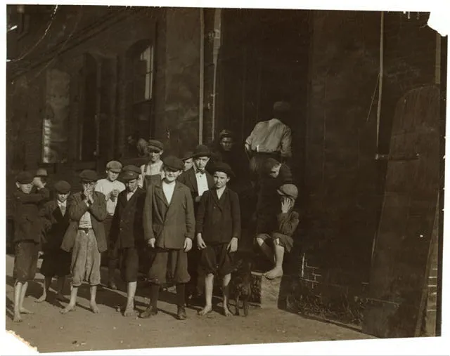 A few of the youngsters working in the Cigarette Factory of the American Tobacco Co., Petersburg, Va. All work. I went through the factory during working hours and saw dozens of little boys and girls working and helping, who were apparently from 11 to 14 years old. Many of the smallest ones would not be photographed. Photo at 6:30 A.M.  Location: Petersburg, Virginia.