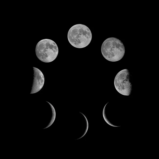 A stunning black and white image showcasing the lunar phases against a dark background.