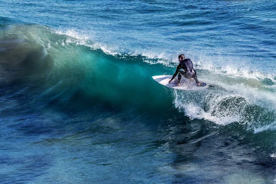 A thrilling capture of a surfer skillfully riding a wave in the open ocean, showcasing the excitement of surfing.