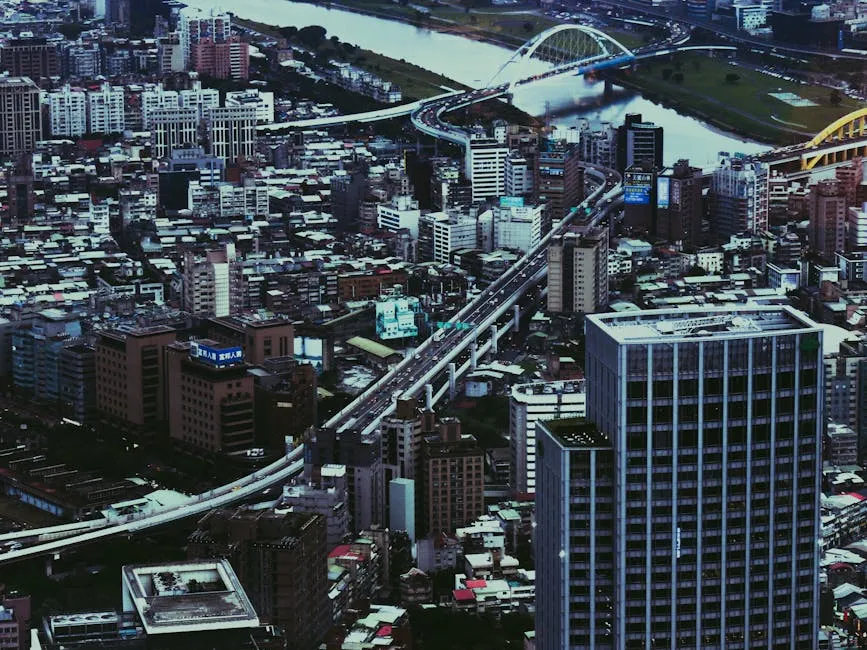 Aerial view of a bustling city with skyscrapers, bridges, and urban infrastructure.