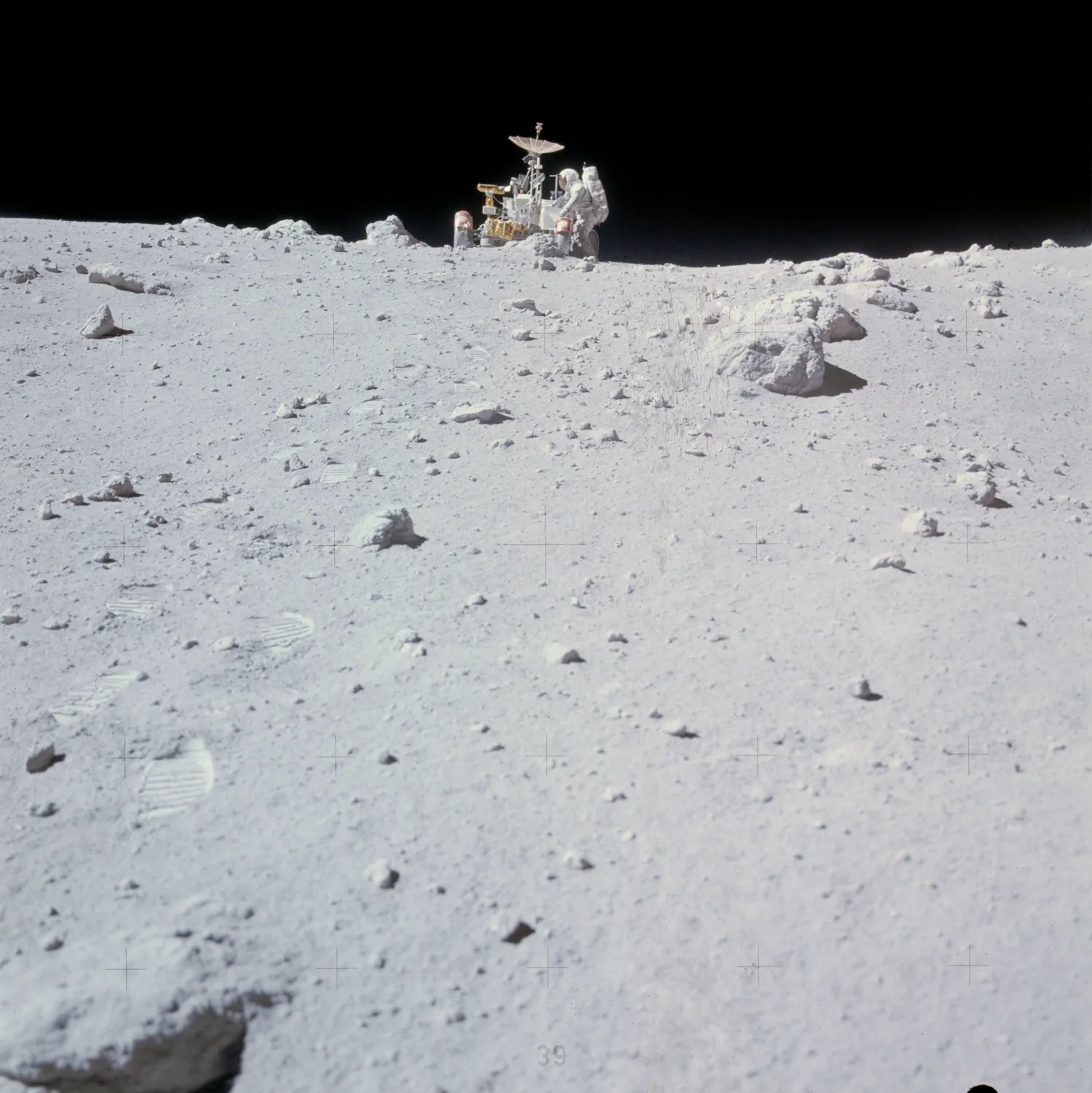 Astronaut Charles Duke works at front of Lunar Roving Vehicle (as16-116-18607)