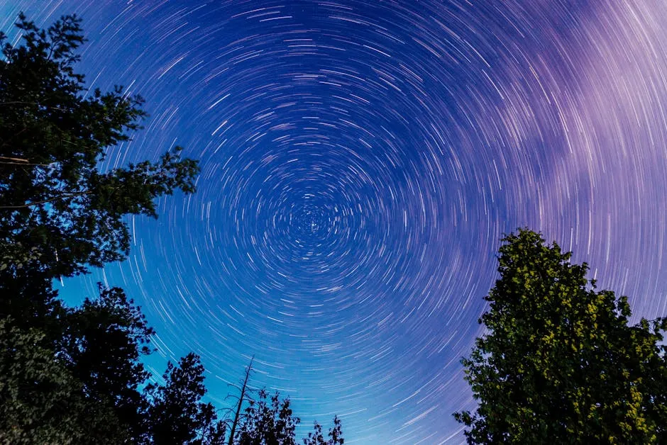 Beautiful long exposure of star trails creating a spiral effect over a forest in Barry's Bay, Ontario, Canada.