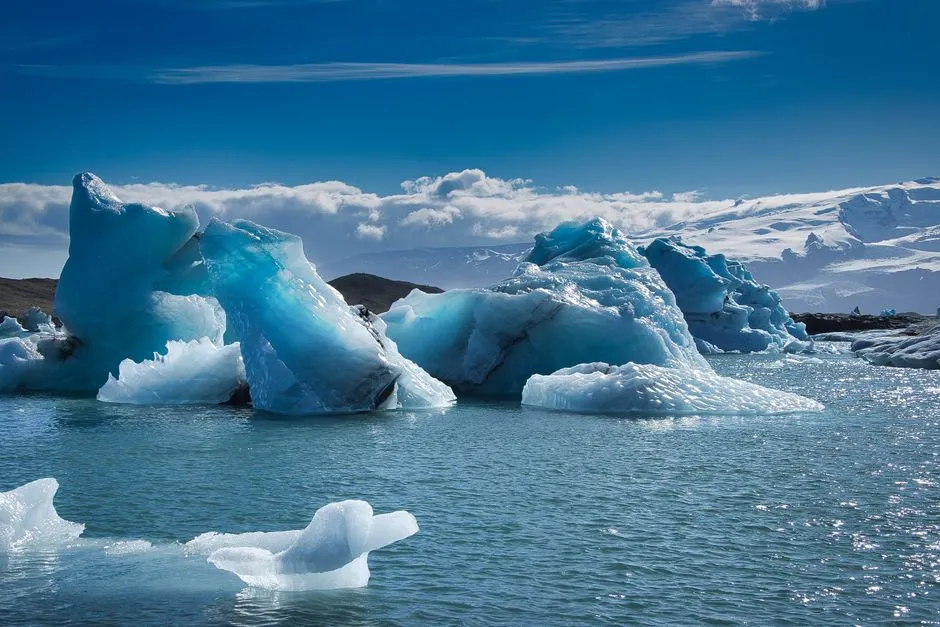 Breathtaking view of icebergs in a serene lagoon in Iceland, illustrating climate change.
