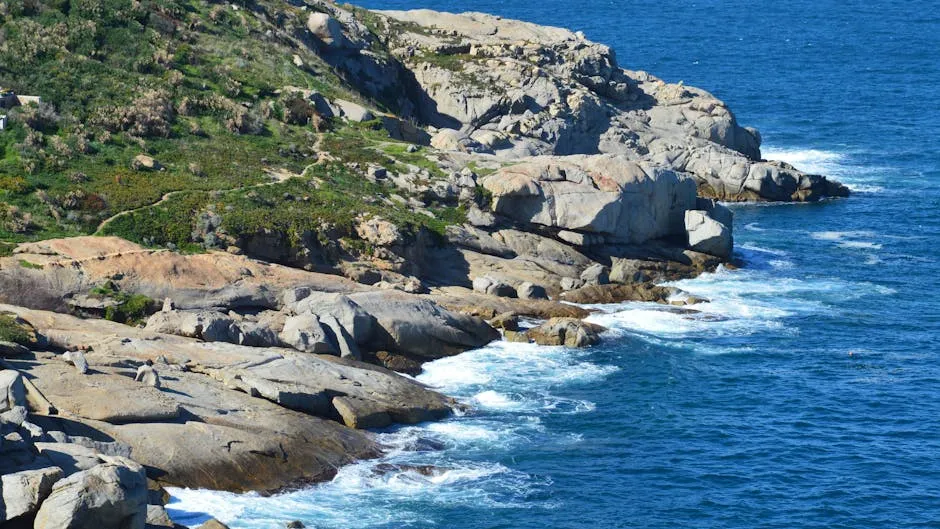 Capture of the rugged rocky coastline meeting the blue sea in Calvi, Corse, France.