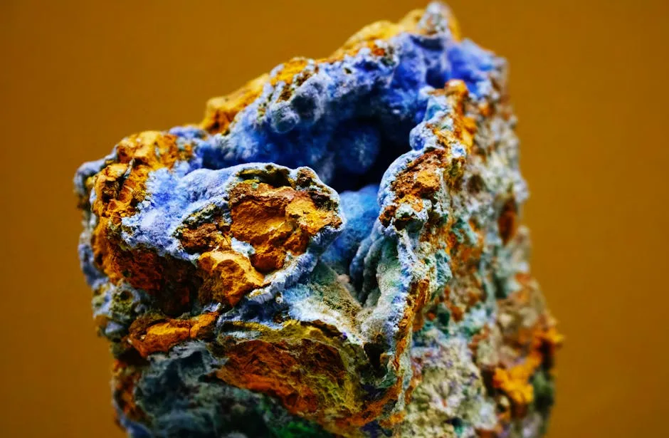 Deep blue azurite clusters on textured orange and brown rock.