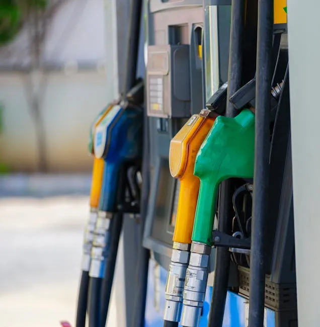 Close-up of vibrant fuel nozzles at a gasoline station showcasing diesel, gas, and petrol options.