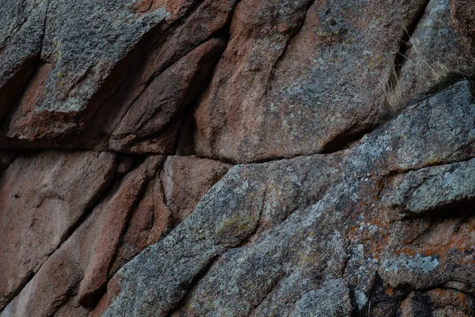 Detailed view of a rugged granite rock surface showing textures and patterns.