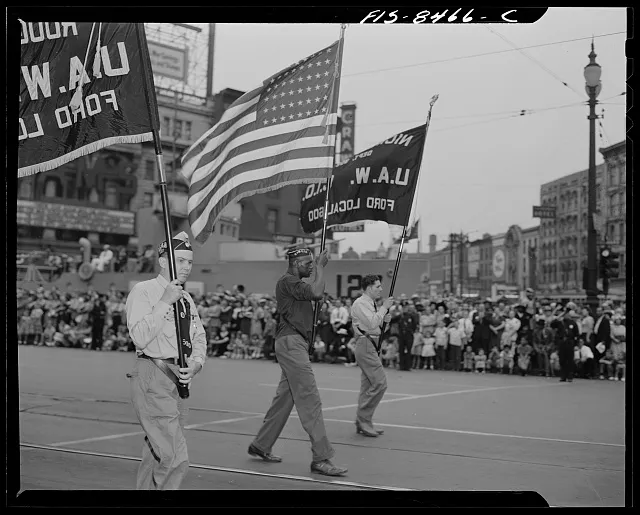 Detroit, Michigan. Ford workers carrying American flag and union banners in the Labor Day parade