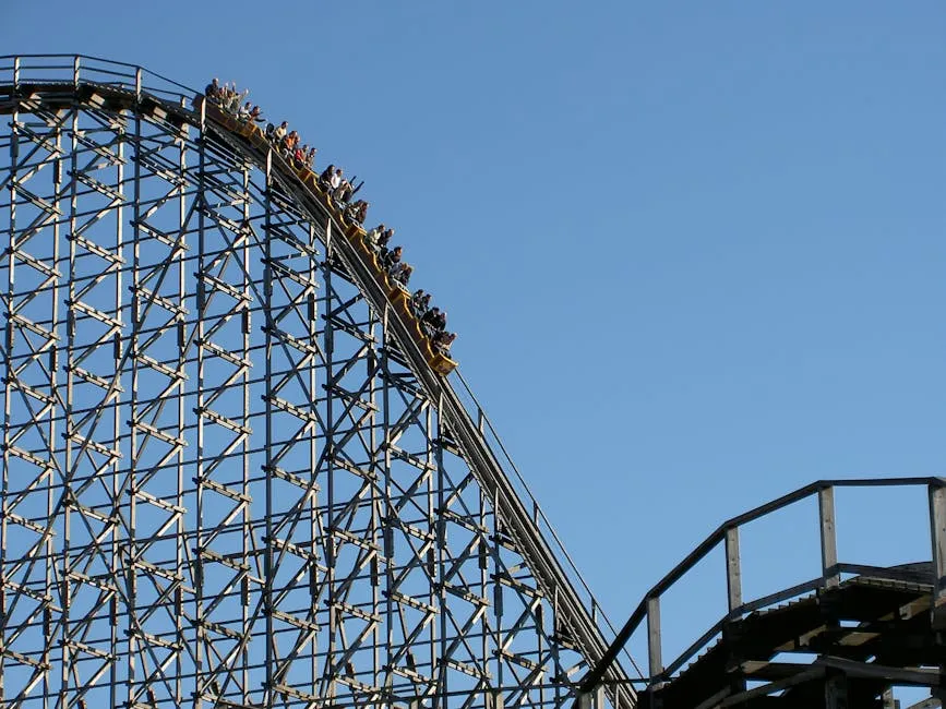 Experience the exhilarating thrill of a roller coaster ascending the steep peak at an amusement park.