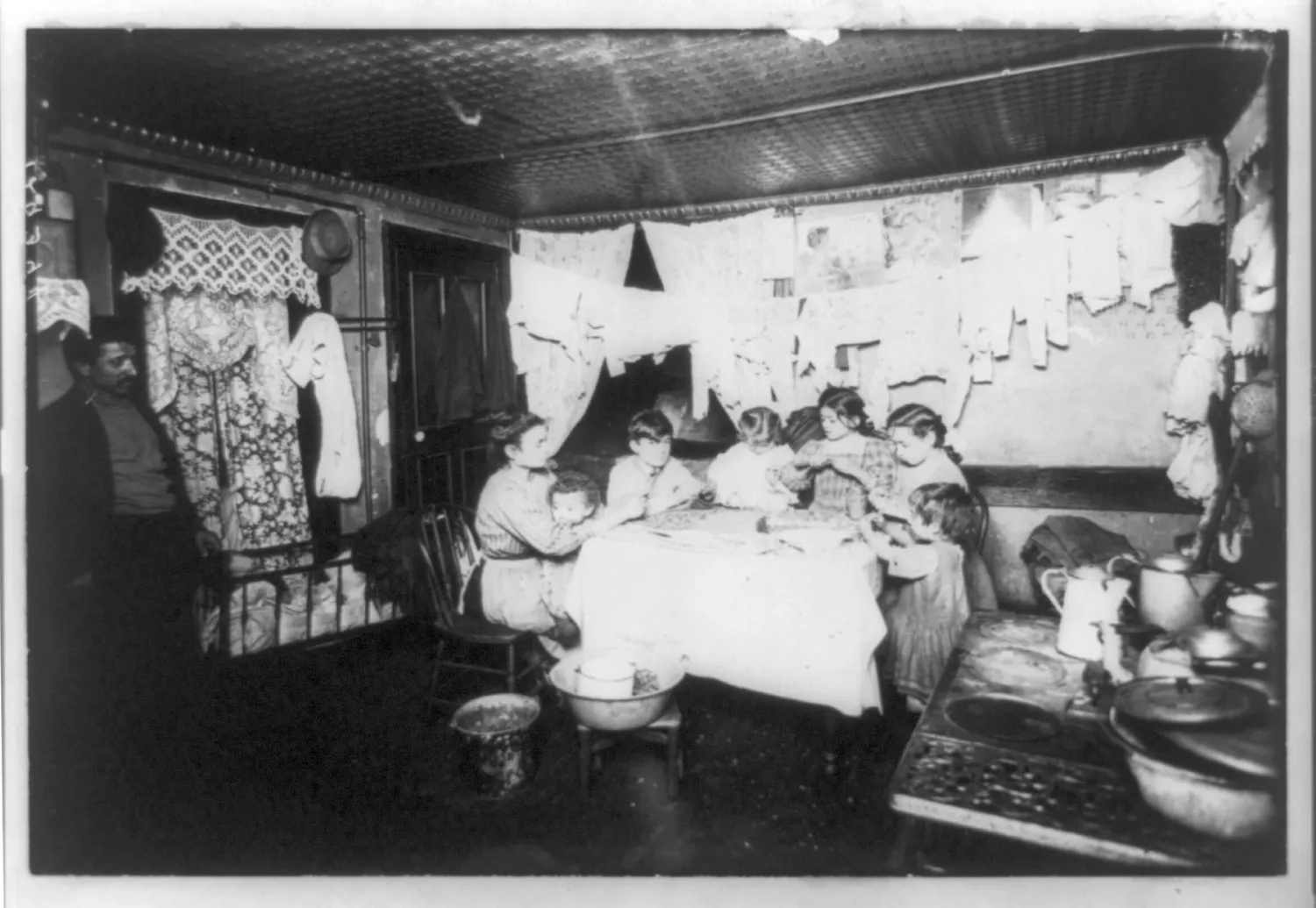 In a New York tenement house - the whole family at work taking out the pecan kernels LCCN96509935.jpg