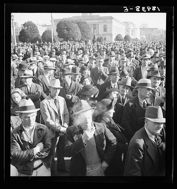 Listening to speeches at mass meeting of Works Progress Administration (WPA) workers protesting congressional cut of relief appropriations. San Francisco, California