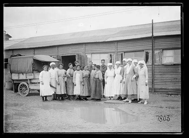 Miss Wills, her staff and French help in front of the American Red Cross line-of-communication Canteen at Is-sur-Tille