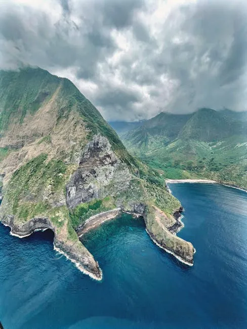 Stunning aerial shot of Molokai's rugged cliffs and coastline, showcasing Hawaii's natural beauty.