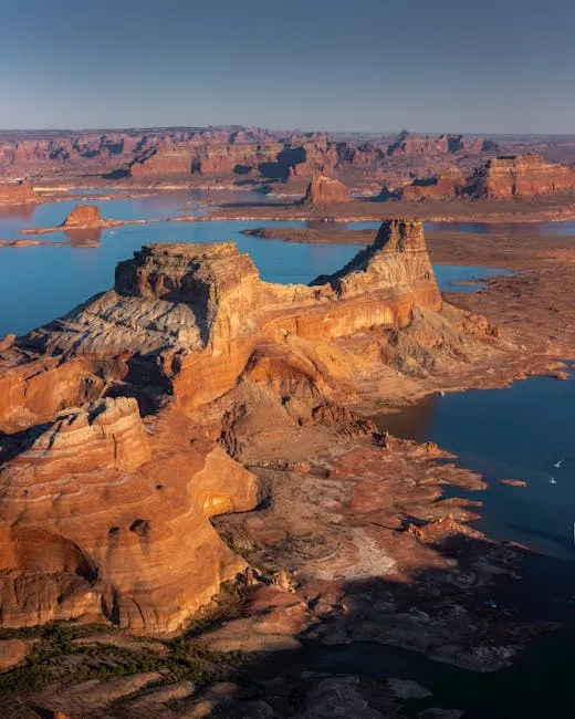 Stunning aerial view of Utah's breathtaking canyon landscape with a scenic lake at sunset.