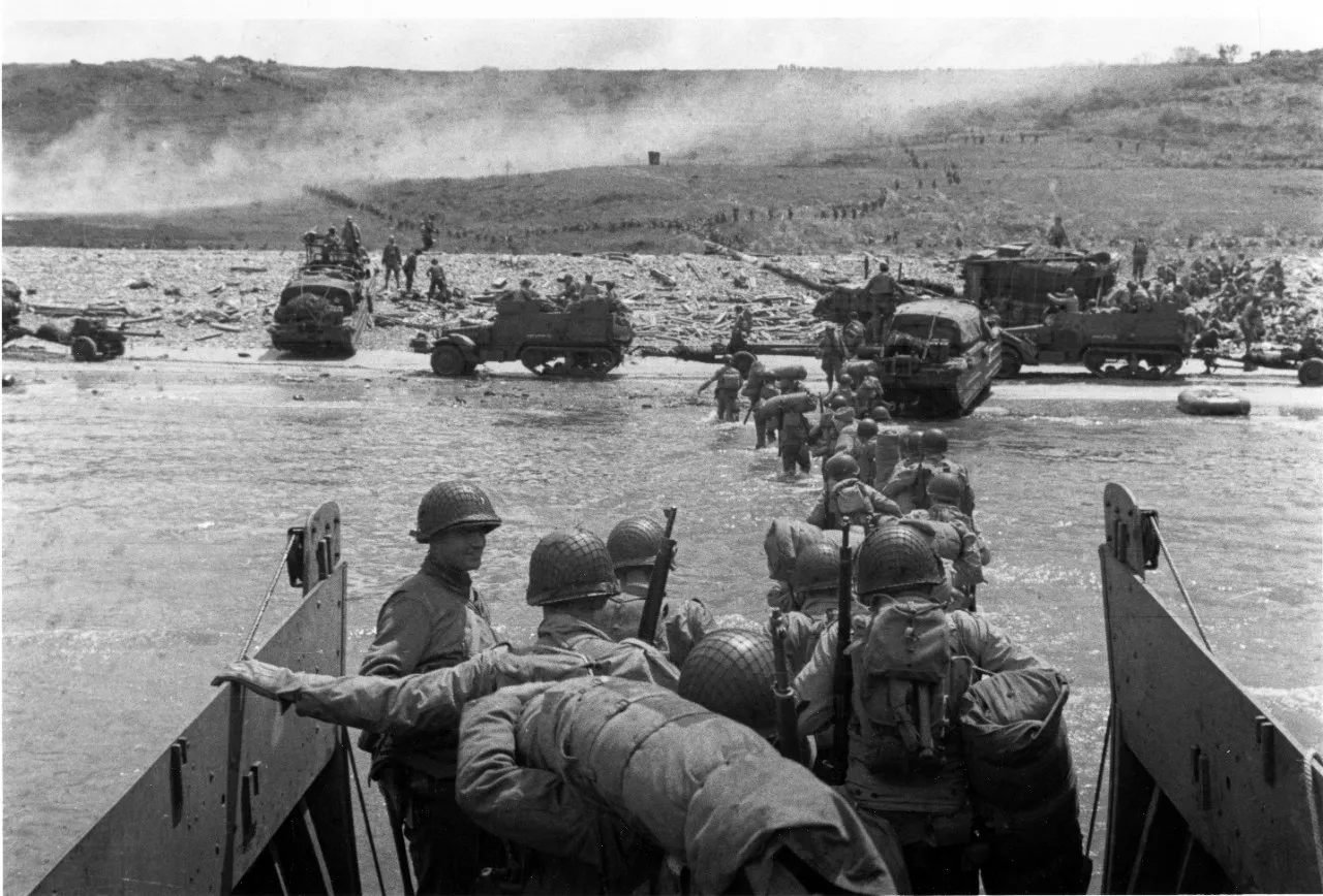 Troops wade ashore at Omaha Beach from a LCVP landing craft.jpg