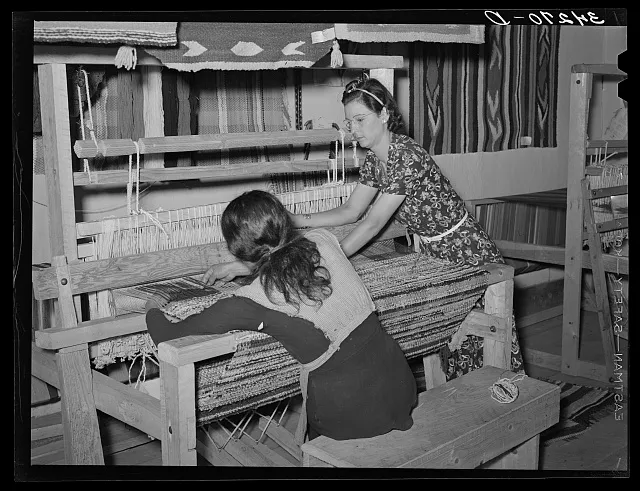 WPA (Works Progress Administration/Work Projects Administration) supervisor instructing Spanish-American woman in weaving of rag rug. WPA project. Costilla, New Mexico