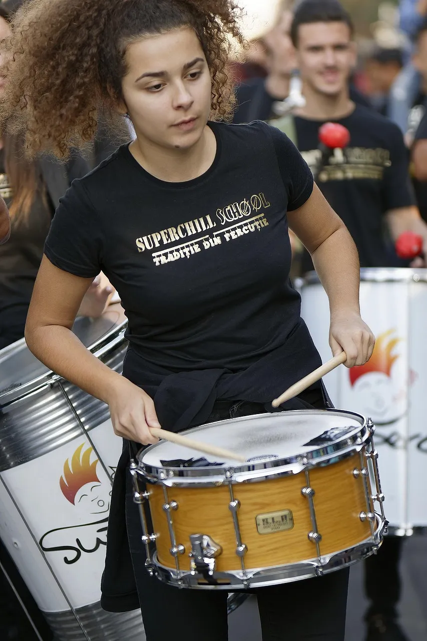 girl, young, hair, long, curly, t-shirt, black, beating, the drum, the sticks, young people, group, show, public, the street, urban, holiday, september